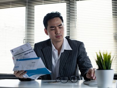 Man calculates the debt at hand with a calculator.